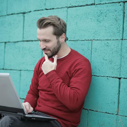 Happy person working at a laptop with good posture
